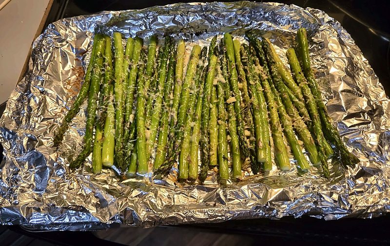Roasted asparagus spears with garlic and parmesan on foil